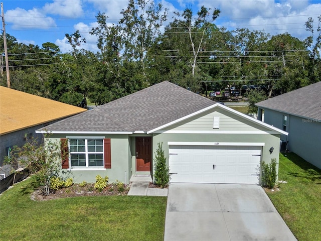 view of front of home with a garage and a front lawn