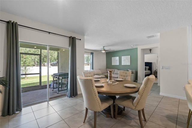 tiled dining area with a textured ceiling