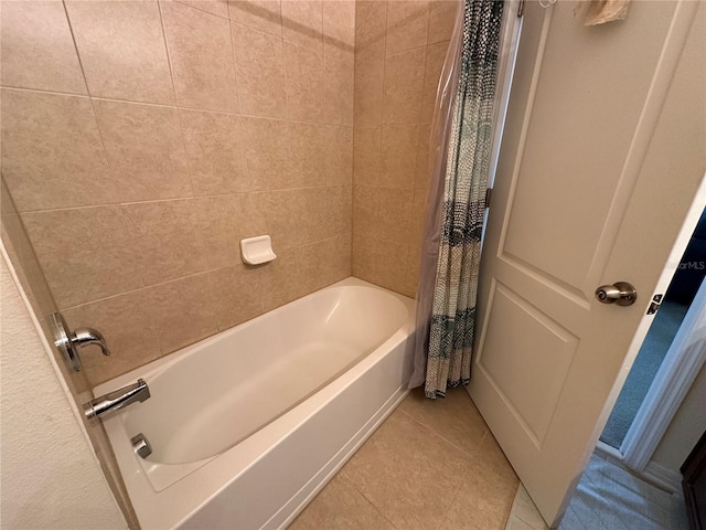 bathroom with tile patterned flooring and shower / bath combo with shower curtain