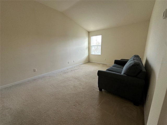 sitting room featuring light colored carpet and vaulted ceiling