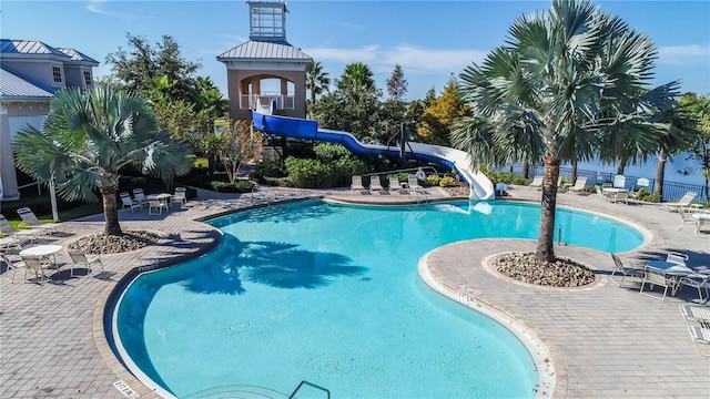 view of pool featuring a patio area and a water slide