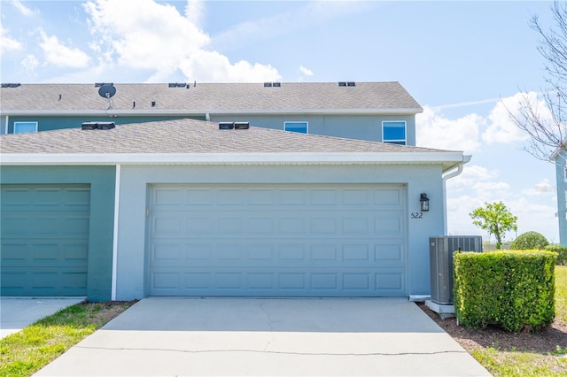 garage with central AC and driveway