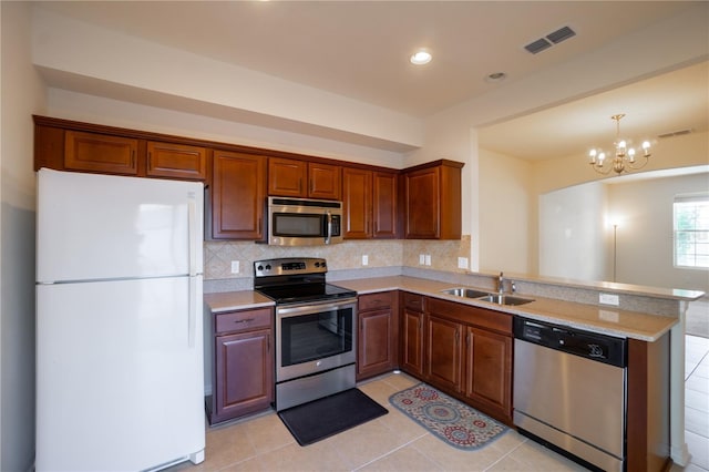 kitchen featuring stainless steel appliances, light countertops, visible vents, and a sink