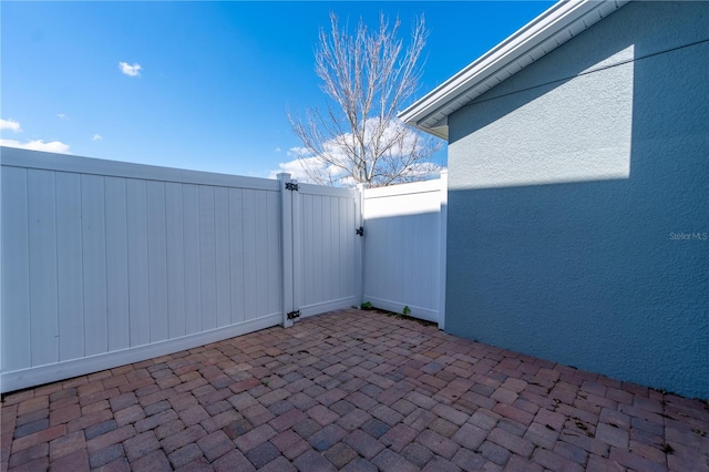 view of patio featuring a gate and fence