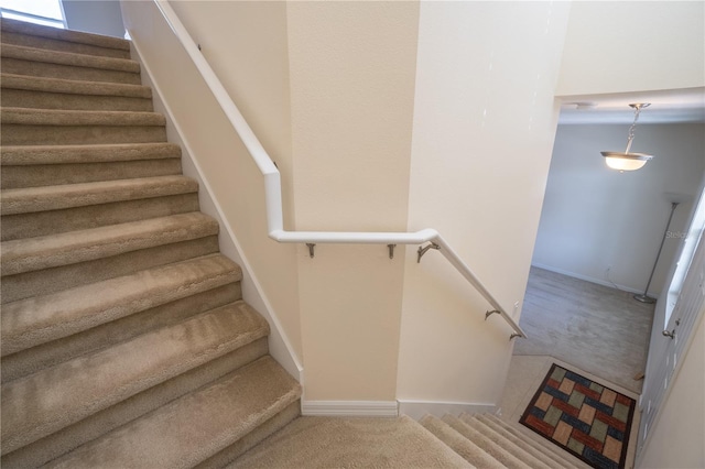 stairway with carpet floors and baseboards