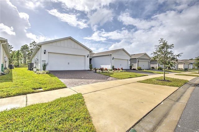 single story home with a garage, central AC, and a front yard