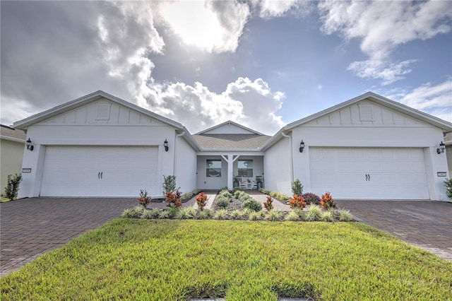 ranch-style house with a garage and a front lawn