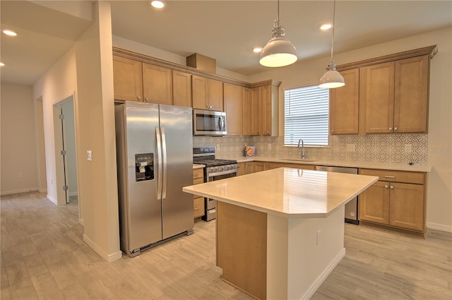 kitchen with stainless steel appliances, backsplash, hanging light fixtures, light hardwood / wood-style flooring, and a kitchen island