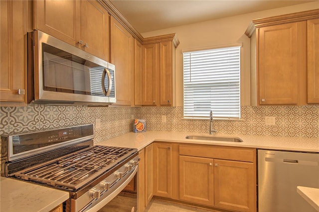 kitchen featuring sink, decorative backsplash, and appliances with stainless steel finishes