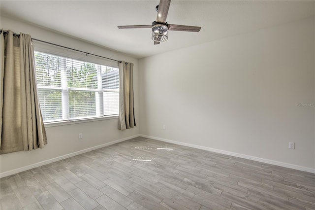 empty room with light wood-type flooring and ceiling fan