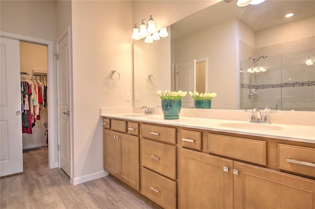 bathroom featuring wood-type flooring, vanity, and a shower with door