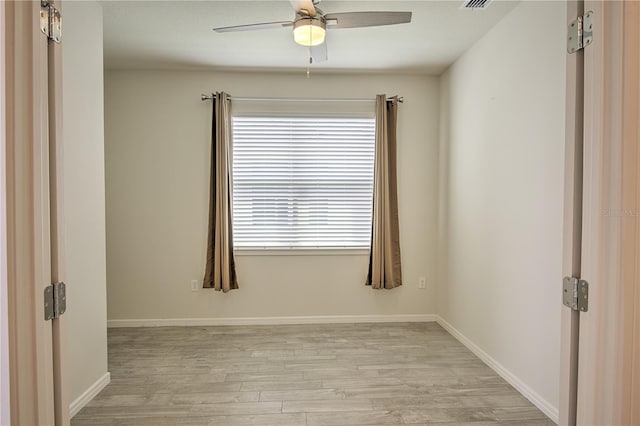 spare room featuring light hardwood / wood-style floors and ceiling fan