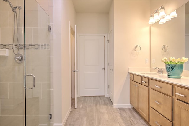 bathroom featuring walk in shower, wood-type flooring, and vanity