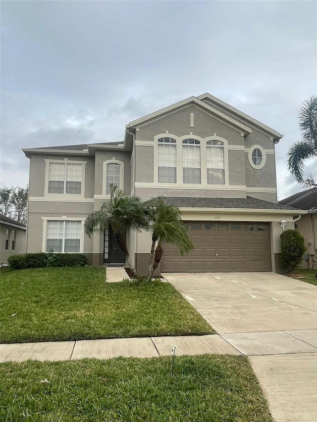 front of property featuring a garage and a front yard