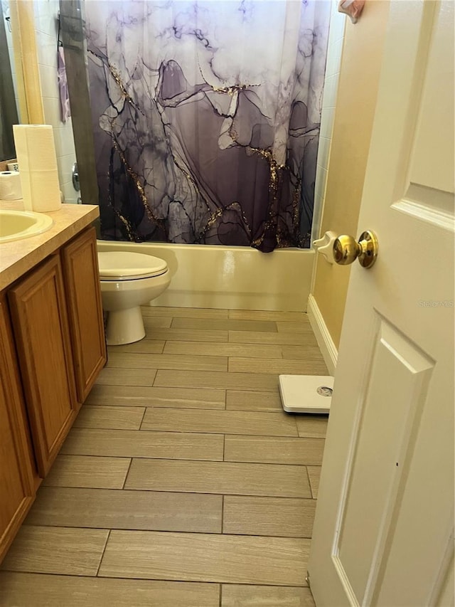 full bathroom with hardwood / wood-style floors, vanity, toilet, and shower / bathtub combination with curtain