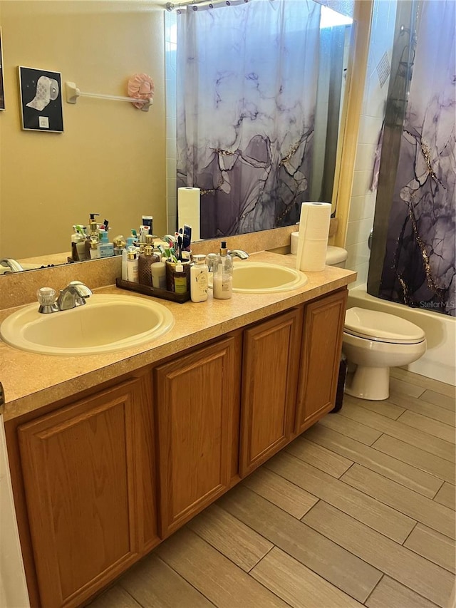 full bathroom with wood-type flooring, vanity, toilet, and shower / tub combo with curtain