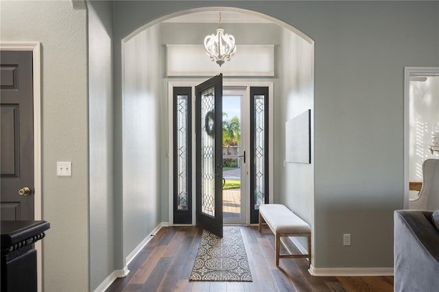 entryway featuring dark hardwood / wood-style flooring and an inviting chandelier