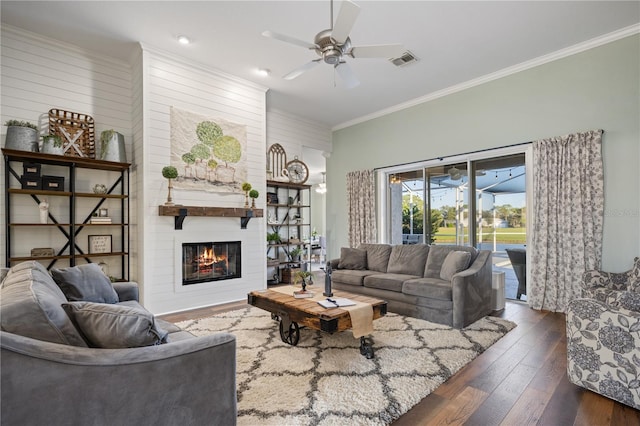 living room featuring a fireplace, ceiling fan, dark hardwood / wood-style flooring, and ornamental molding