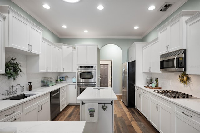 kitchen featuring appliances with stainless steel finishes, white cabinetry, and a kitchen island