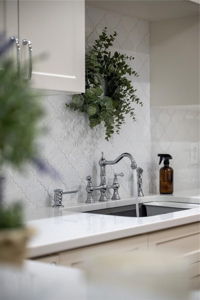 room details featuring tasteful backsplash and sink