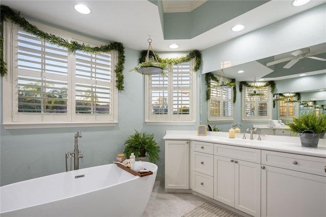 bathroom with a bathing tub, ceiling fan, tile patterned floors, and vanity