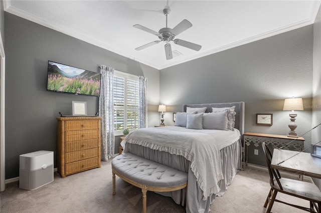 carpeted bedroom featuring ceiling fan and ornamental molding