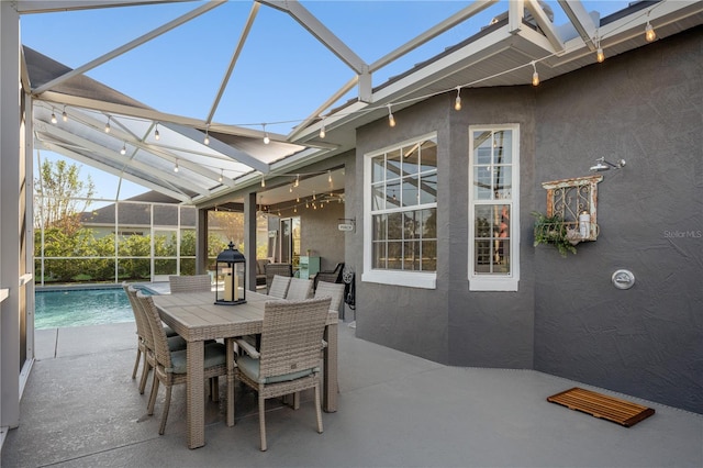 view of patio featuring glass enclosure