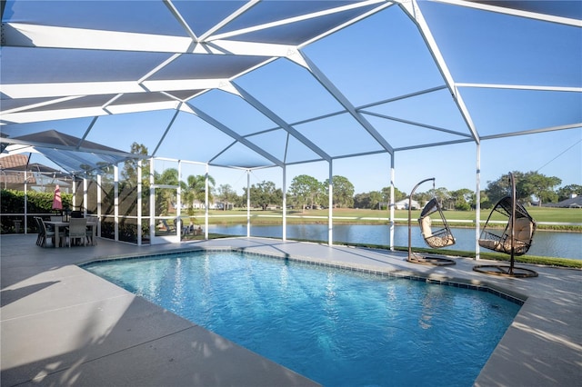 view of swimming pool featuring glass enclosure, a water view, and a patio