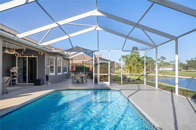 view of swimming pool with a lanai, a patio, and a water view