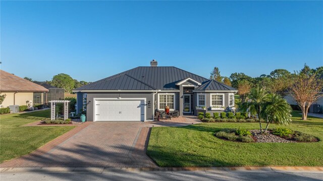 view of front of home featuring a garage and a front yard