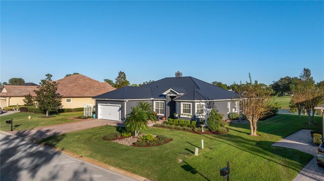 ranch-style house featuring a front lawn and a garage