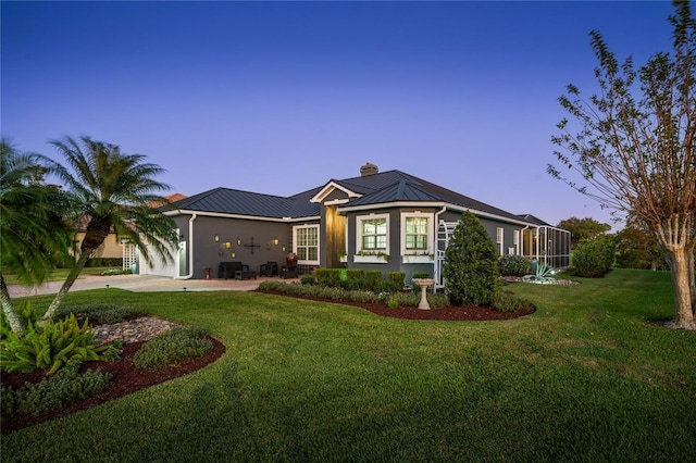 ranch-style home featuring a lawn