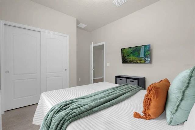 carpeted bedroom featuring a closet