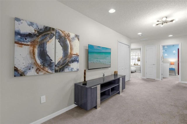 hallway featuring carpet and a textured ceiling