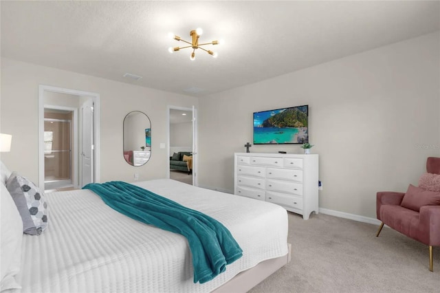 bedroom featuring a chandelier, ensuite bath, and light carpet