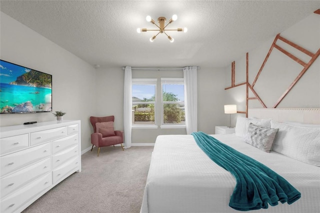 bedroom with light carpet, a textured ceiling, and an inviting chandelier