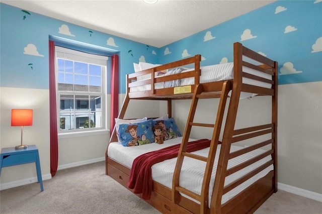 bedroom with a textured ceiling and light colored carpet