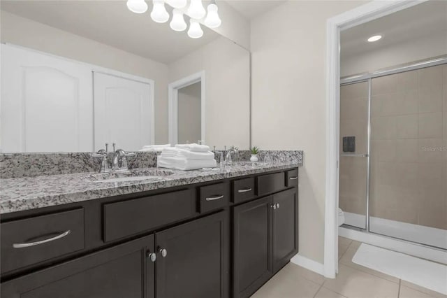 bathroom featuring vanity, tile patterned flooring, and a shower with door