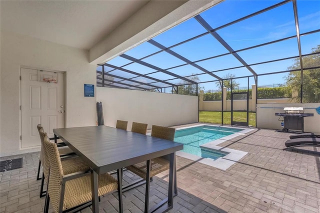 view of swimming pool with glass enclosure and a patio area