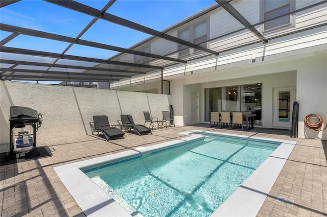 view of swimming pool with a patio, grilling area, and a lanai