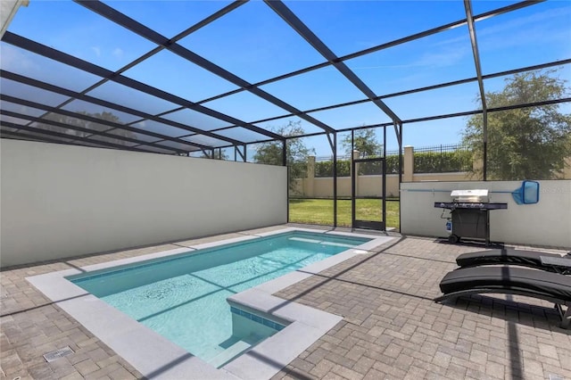 view of swimming pool with glass enclosure and a patio area