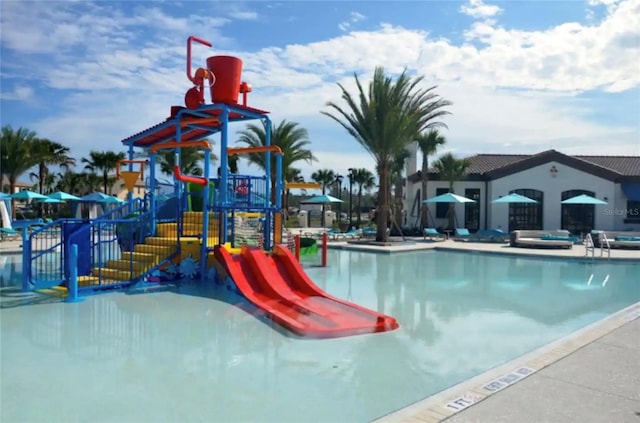 view of pool featuring a playground