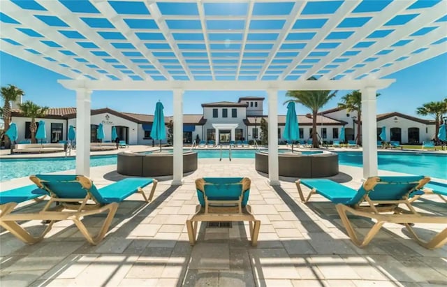 view of patio with a pergola and a community pool