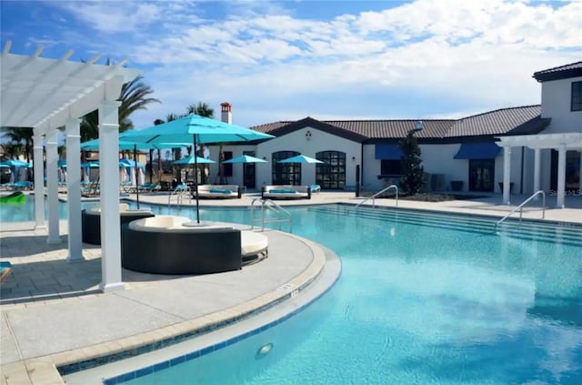 view of swimming pool featuring a patio area and a pergola