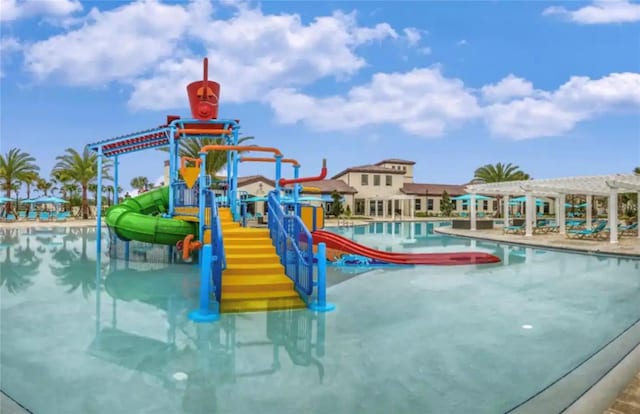 view of pool with a playground and a water slide