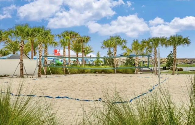 view of home's community with a water view and volleyball court