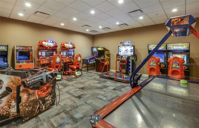 rec room with a paneled ceiling