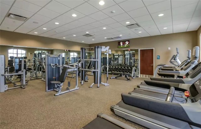 gym with carpet flooring and a paneled ceiling