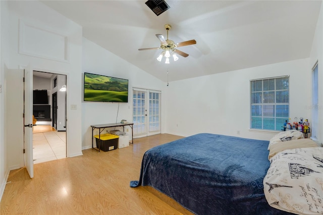 bedroom with hardwood / wood-style floors, ceiling fan, and lofted ceiling