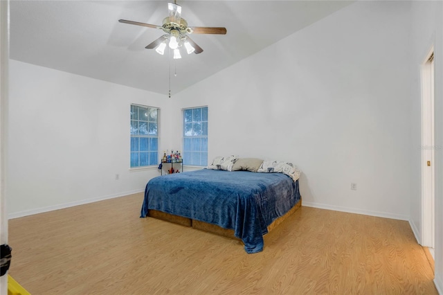 bedroom featuring light wood-type flooring, ceiling fan, and vaulted ceiling